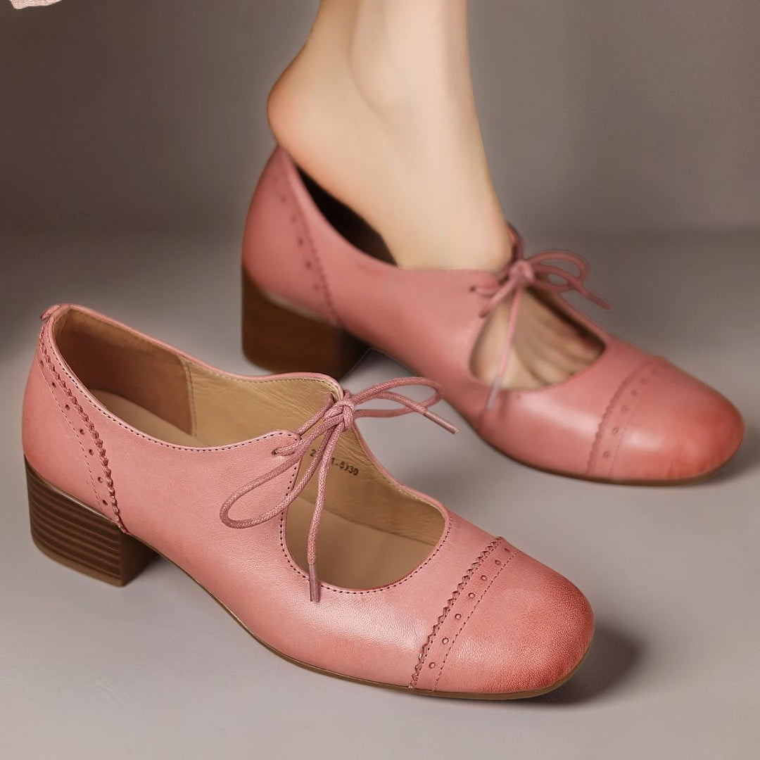 Vivian &amp; Cole Constance pink carved leather oxfords with a low block heel and lace-up closure on a model
