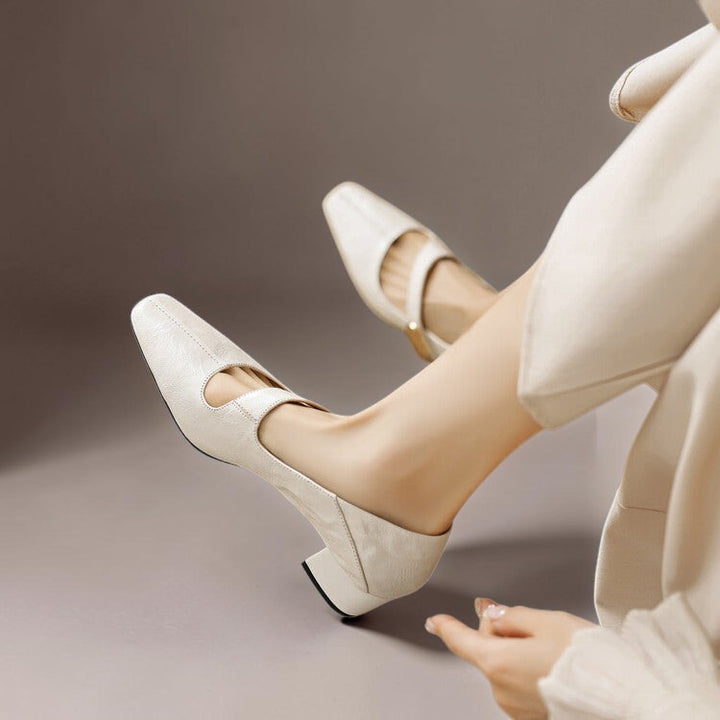 Vivian &amp; Cole cream leather Mary Jane pumps with a chiseled square toe, cut-out vamp, and low block heel.