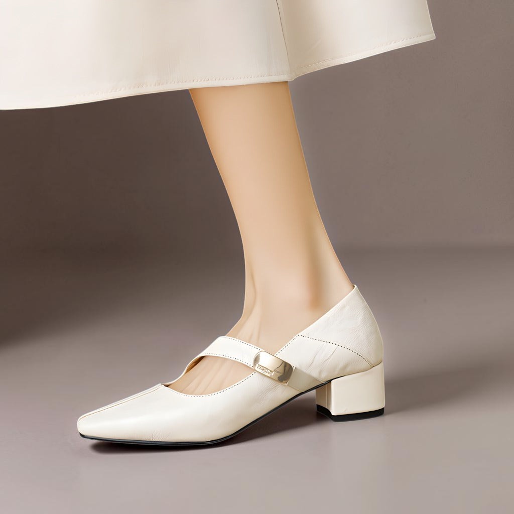 Vivian &amp; Cole cream leather Mary Jane pump with a chiseled square toe, gold bit accent, and low block heel.