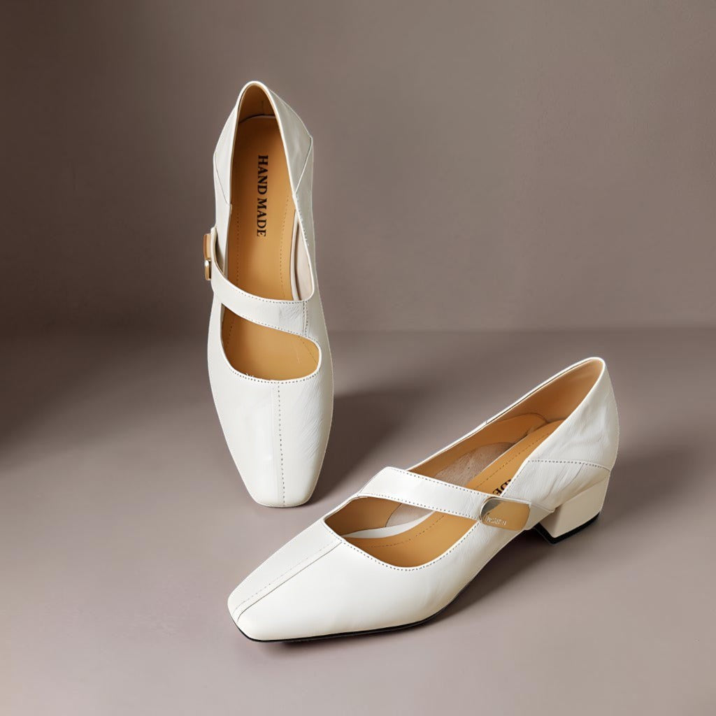 Vivian &amp; Cole cream leather Mary Jane pumps with a chiseled square toe, gold bit accent, and low block heel.