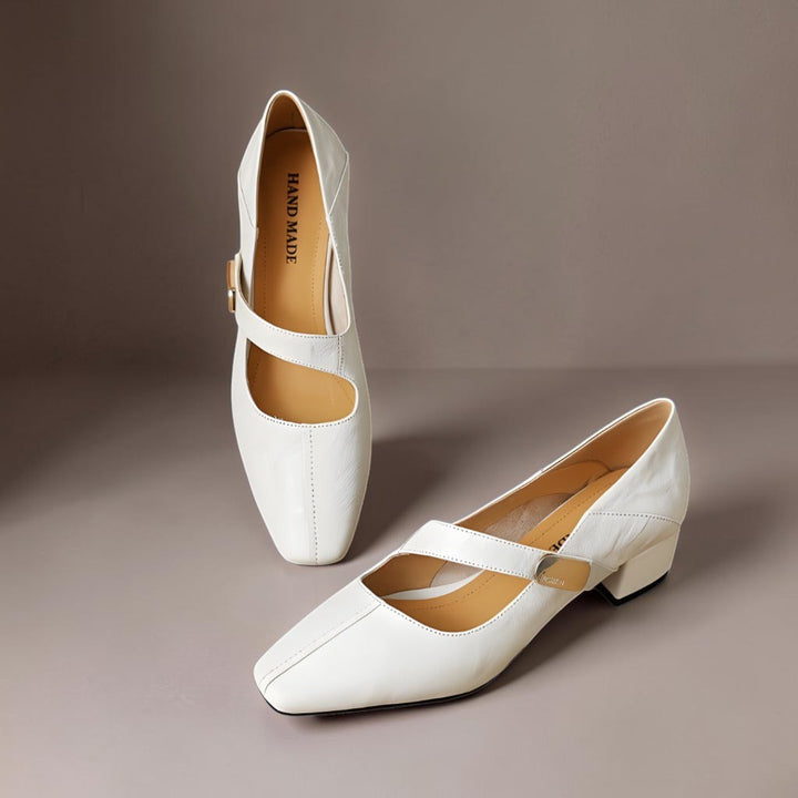 Vivian &amp; Cole cream leather Mary Jane pumps with a chiseled square toe, gold bit accent, and low block heel.