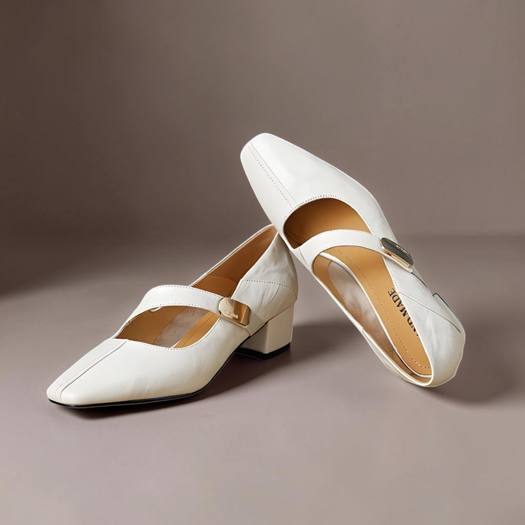 Vivian &amp; Cole Quera cream leather Mary Jane pumps with a chiseled square toe, gold bit accent, and low block heel.