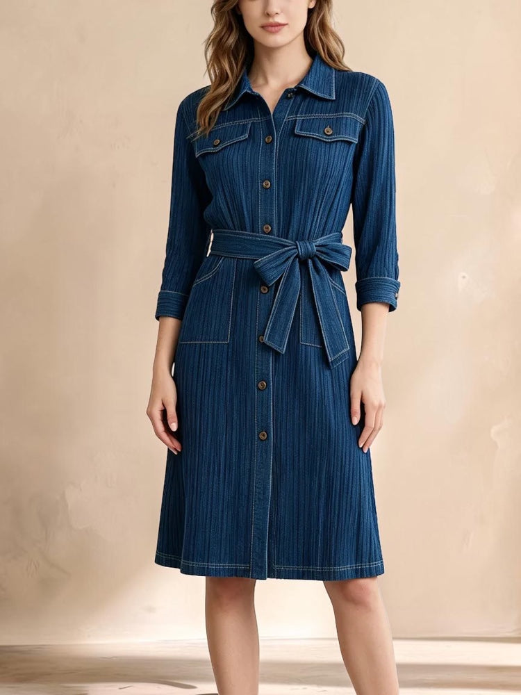 Vivian &amp; Cole deep blue denim-look midi shirt dress with a collared neckline, button front, and a tie-waist belt.