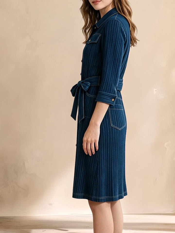 Vivian &amp; Cole Delphine dress in deep blue denim with a collared bodice, tie waist, and textured vertical stripes.