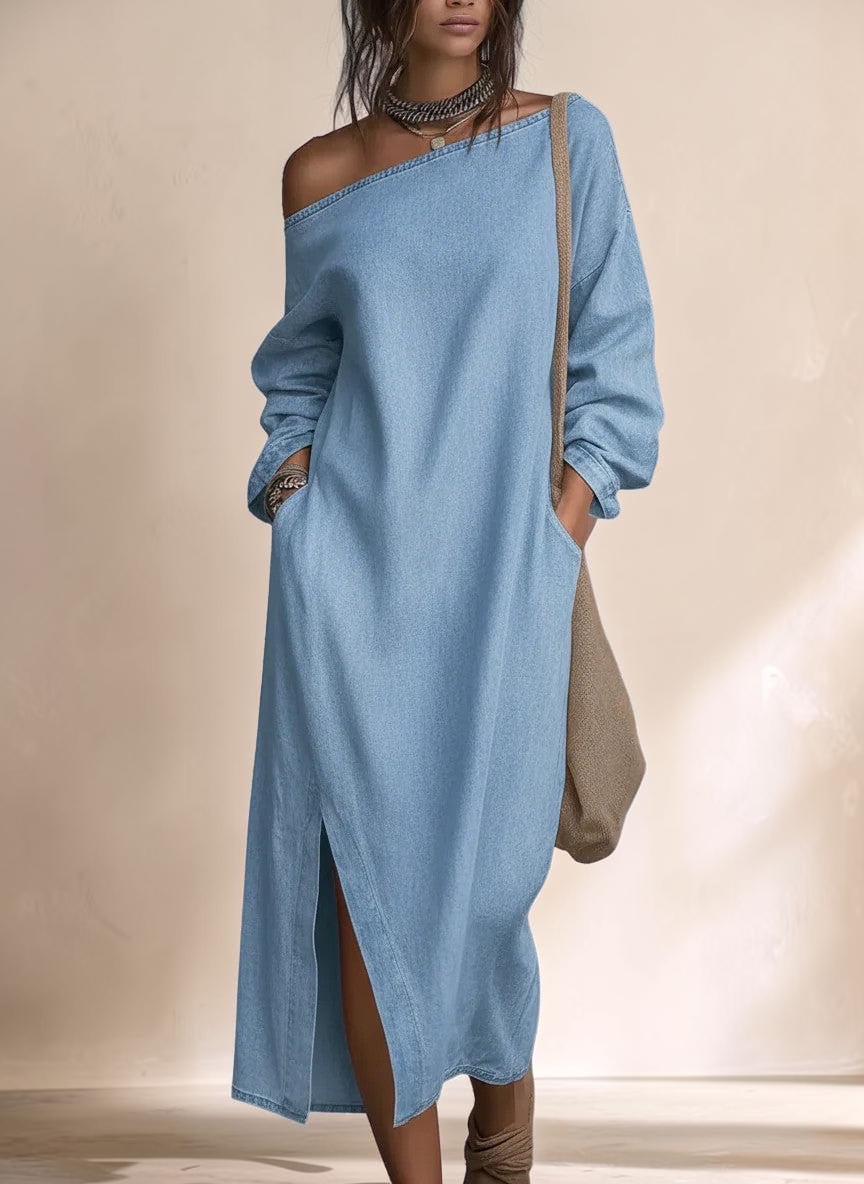 Vivian & Cole light blue denim maxi dress with balloon sleeves, off-shoulder neckline, and side slit on a model.