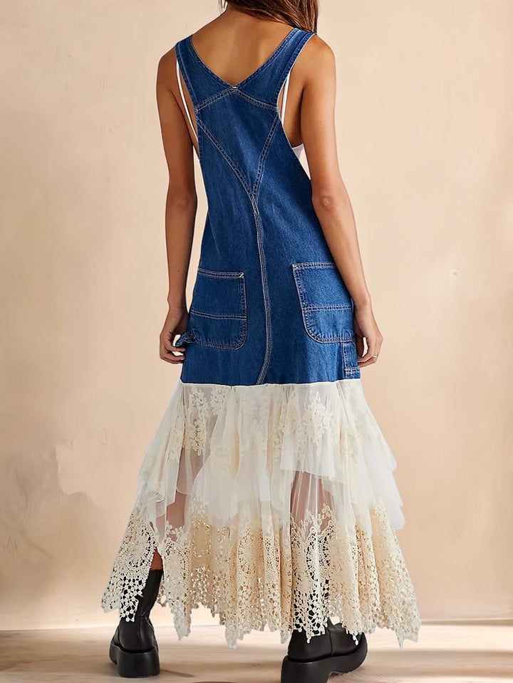 Vivian &amp; Cole blue denim pinafore dress with white lace patchwork hem and adjustable straps, back view on a model.