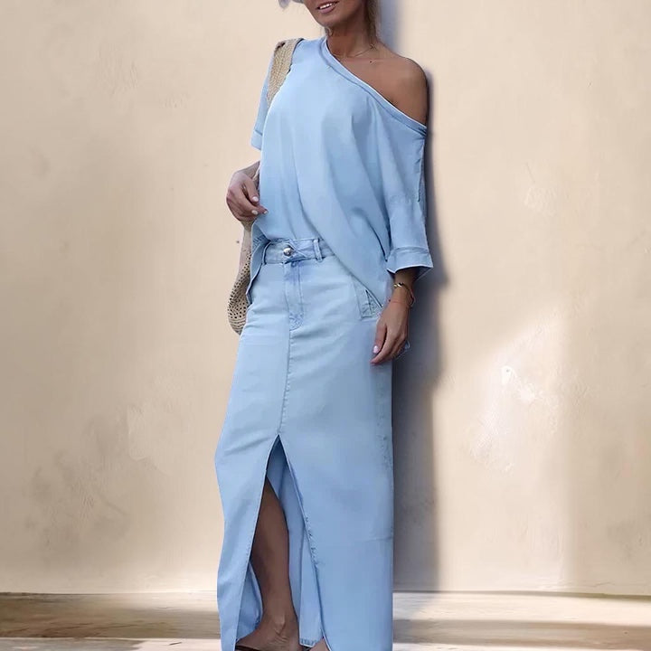 Vivian &amp; Cole light blue denim maxi skirt set featuring an asymmetrical shoulder top and a front slit skirt