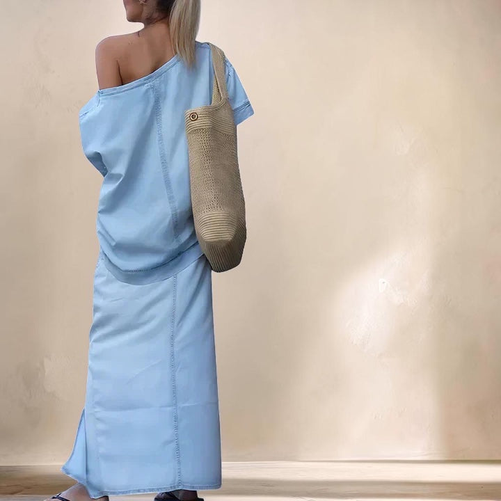 Vivian &amp; Cole light blue denim maxi skirt set featuring an asymmetrical shoulder top and a high front slit skirt