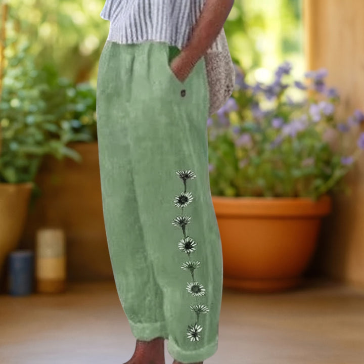 Vivian &amp; Cole Flora green linen-feel loose trousers with floral print detail and elastic waist.