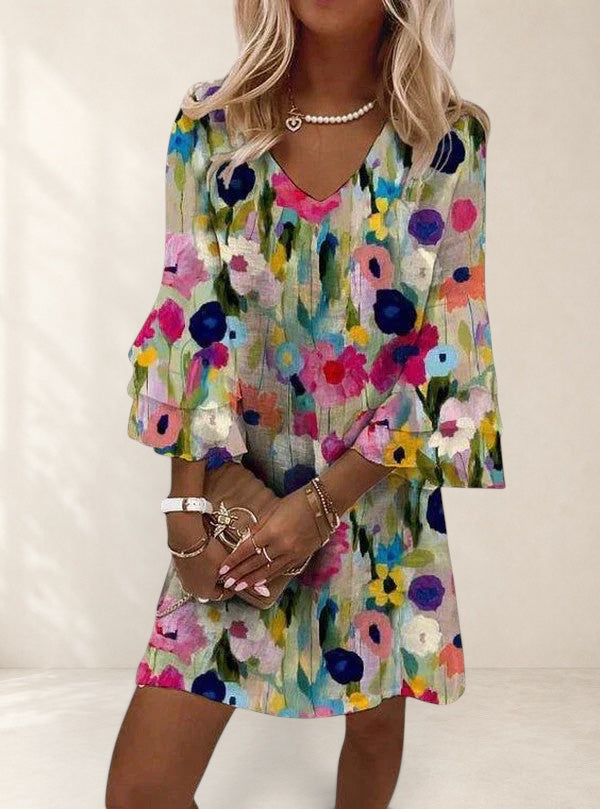 Vivian & Cole Elviera mini dress with a colorful floral print, V-neck, and ruffled sleeves.