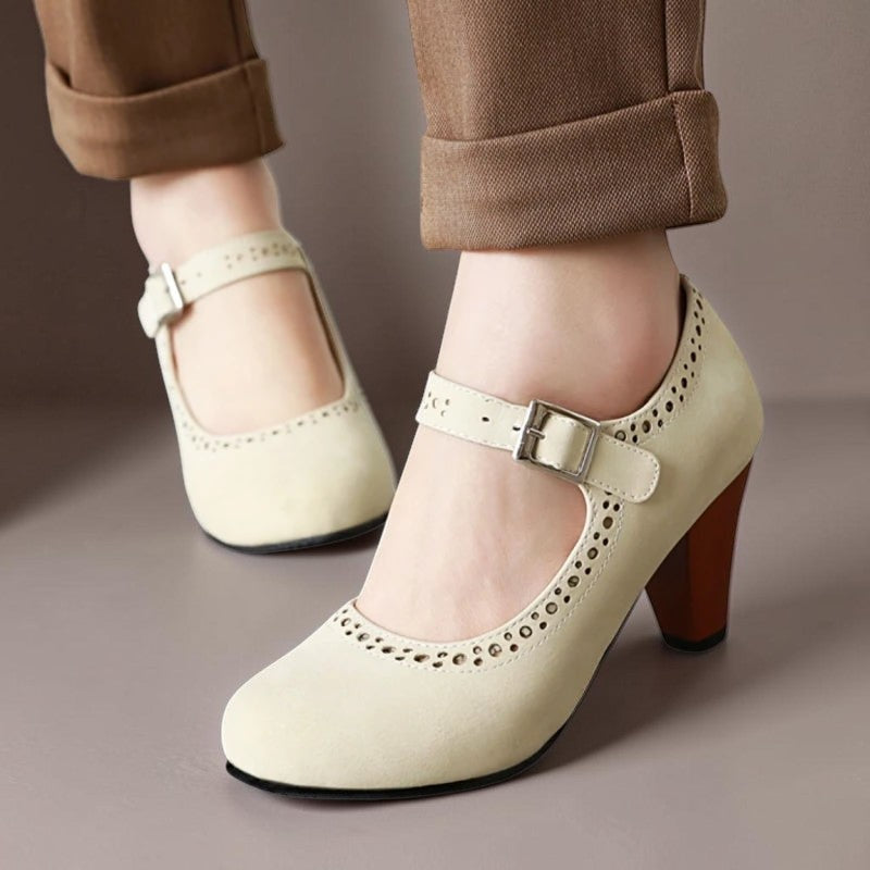 Vivian & Cole Genevieve beige Mary Jane heels with adjustable strap, rounded toe, and decorative laser-cut detailing.
