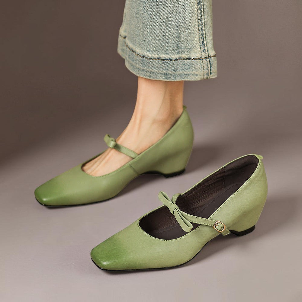 Vivian & Cole Bryony green leather Mary Jane pumps with a bow-strap and concealed block heel worn with jeans