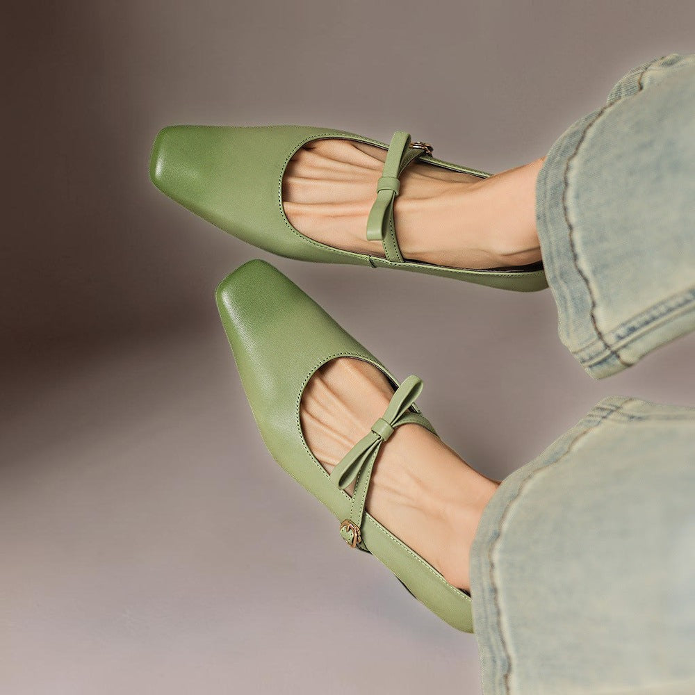 Vivian &amp; Cole Bryony green leather Mary Jane pumps with a bow-tie strap and square toe, worn with light wash jeans.
