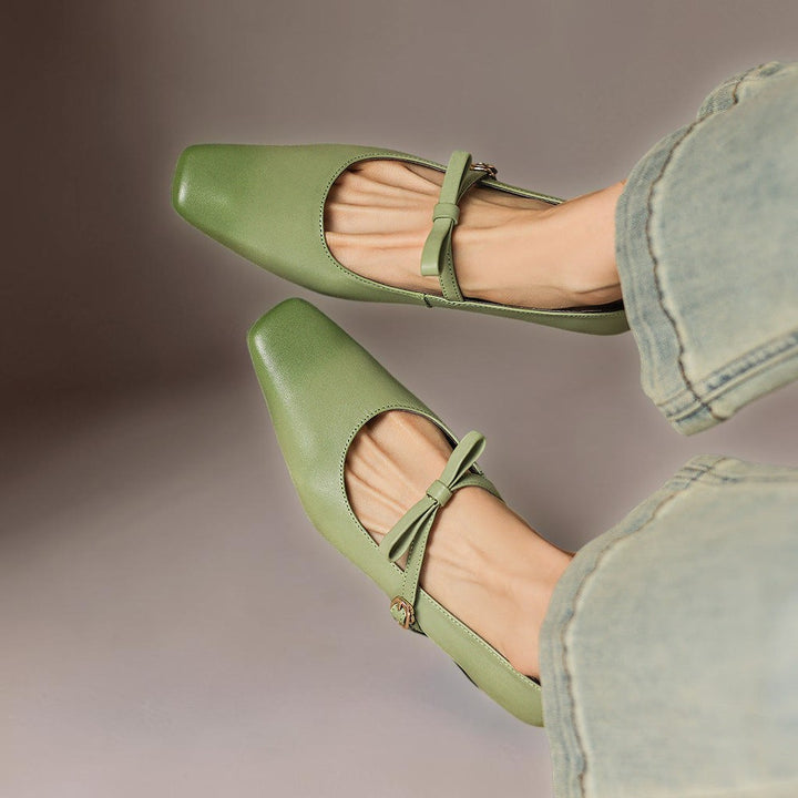 Vivian &amp; Cole Bryony green leather Mary Jane pumps with a bow-tie strap and square toe, worn with light wash jeans.