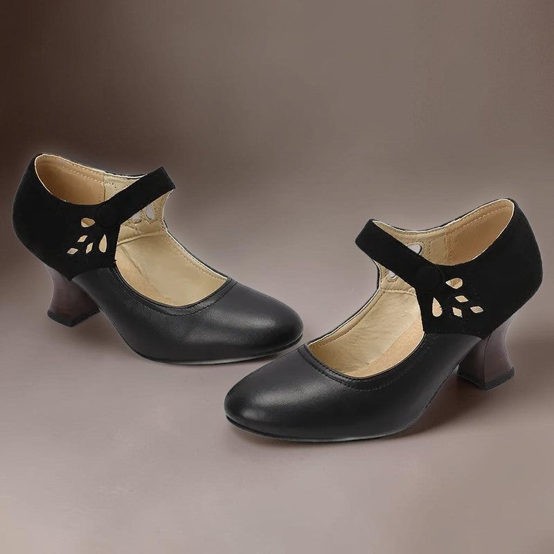 Vivian &amp; Cole Guinevere black Victorian style heels with ankle strap, cutout detail, and stable wooden-look heel.