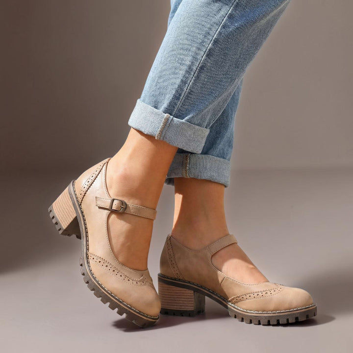 Vivian &amp; Cole Marie khaki T-strap Mary Jane heels with block heels and brogue detailing worn with cuffed blue jeans