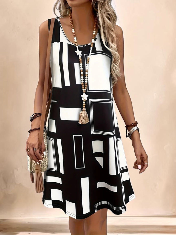Vivian &amp; Cole Marguerite sleeveless A-line dress featuring a bold black and white geometric print and round neckline.