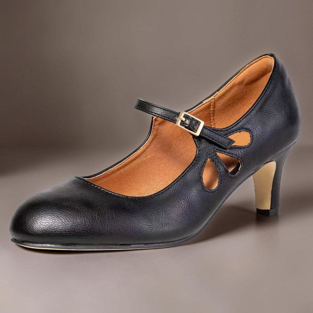Vivian &amp; Cole Odette black leather Mary Jane pumps with a manageable heel, buckle strap, and cushioned interior.