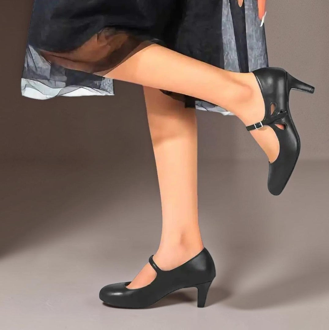 Vivian & Cole Odette classic black office pumps with a comfortable mid-heel and elegant strap detail on a model