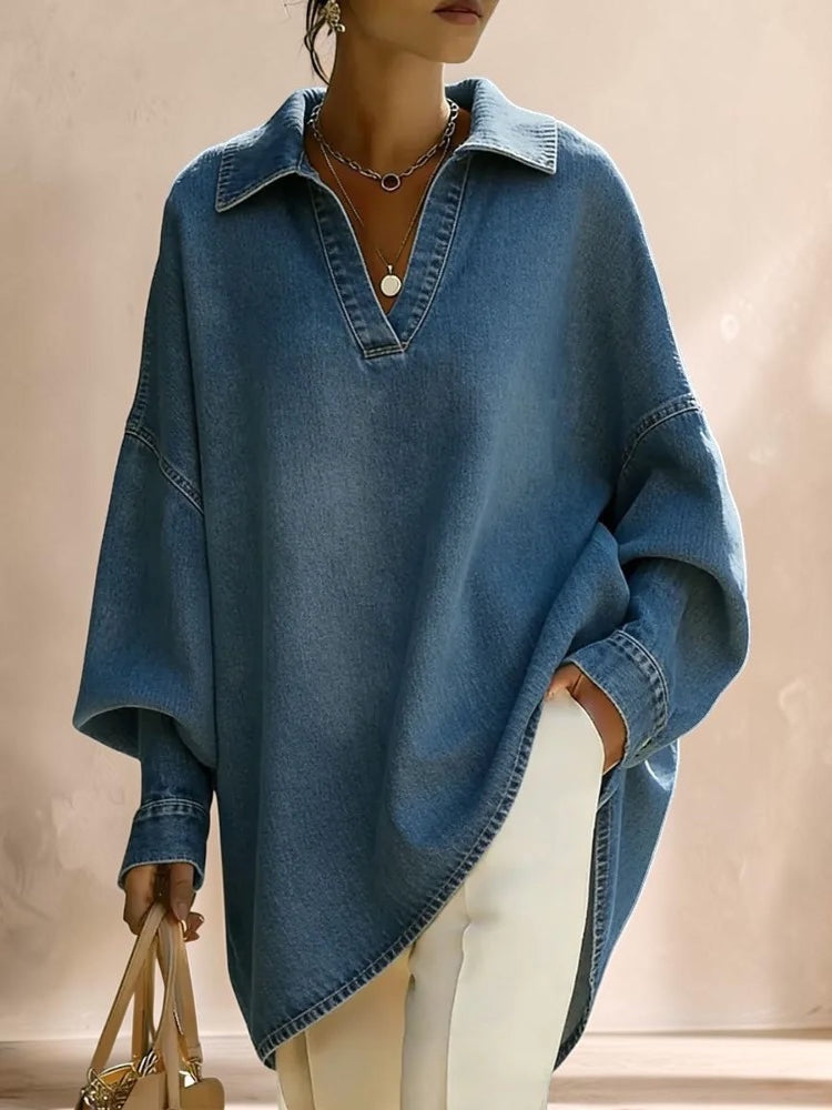 Vivian &amp; Cole Clémence oversized light blue denim shirt with a V-neck lapel and relaxed fit worn over white trousers.