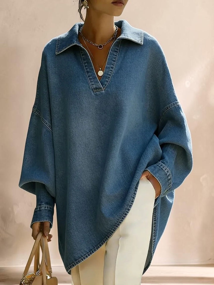 Vivian &amp; Cole Clémence oversized light blue denim shirt with a V-neck lapel and relaxed fit worn over white trousers.