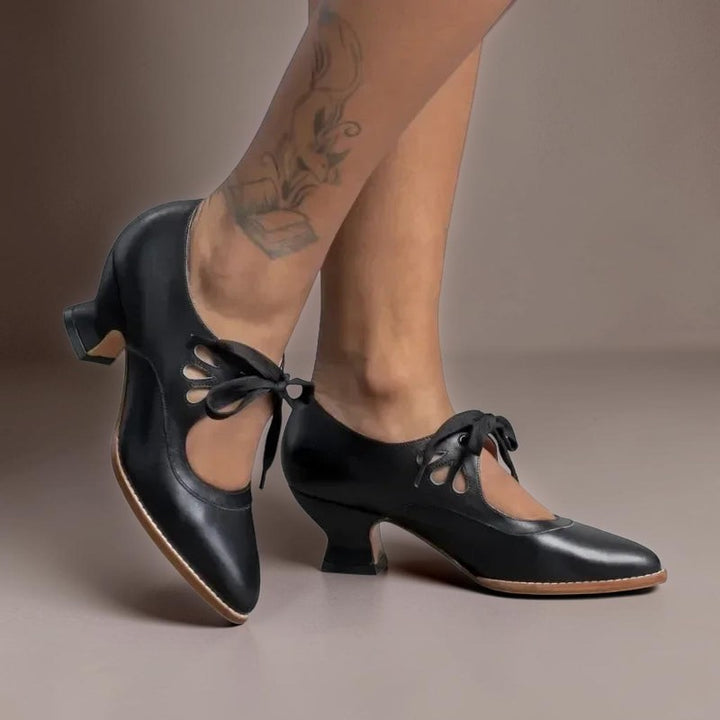 Vivian &amp; Cole Rosalind black vintage lace-up Mary Jane pumps with a rounded toe and low block heel on a model