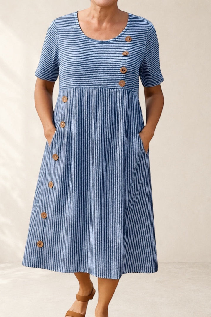 Vivian &amp; Cole blue and white striped midi dress with short sleeves, button details, and side pockets. A-line silhouette.