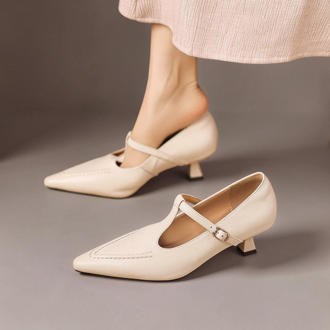 Vivian & Cole Tirea cream genuine leather kitten heel pumps with a pointed toe and adjustable T-strap buckle closure.