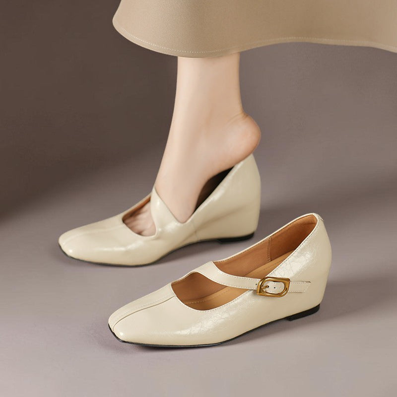 Vivian & Cole Viora cream genuine leather Mary Jane heels with a square toe, tilted buckle strap, and wedge sole.