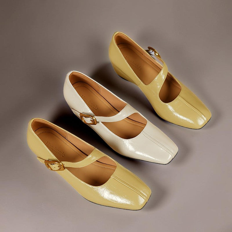Vivian &amp; Cole Viora glossy genuine leather mary jane heels in yellow and cream with square toes and buckle straps.