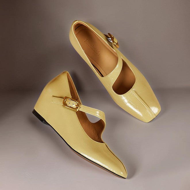 Vivian &amp; Cole Viora glossy yellow leather mary jane heels with a square toe, tilted buckle strap, and wedge sole.