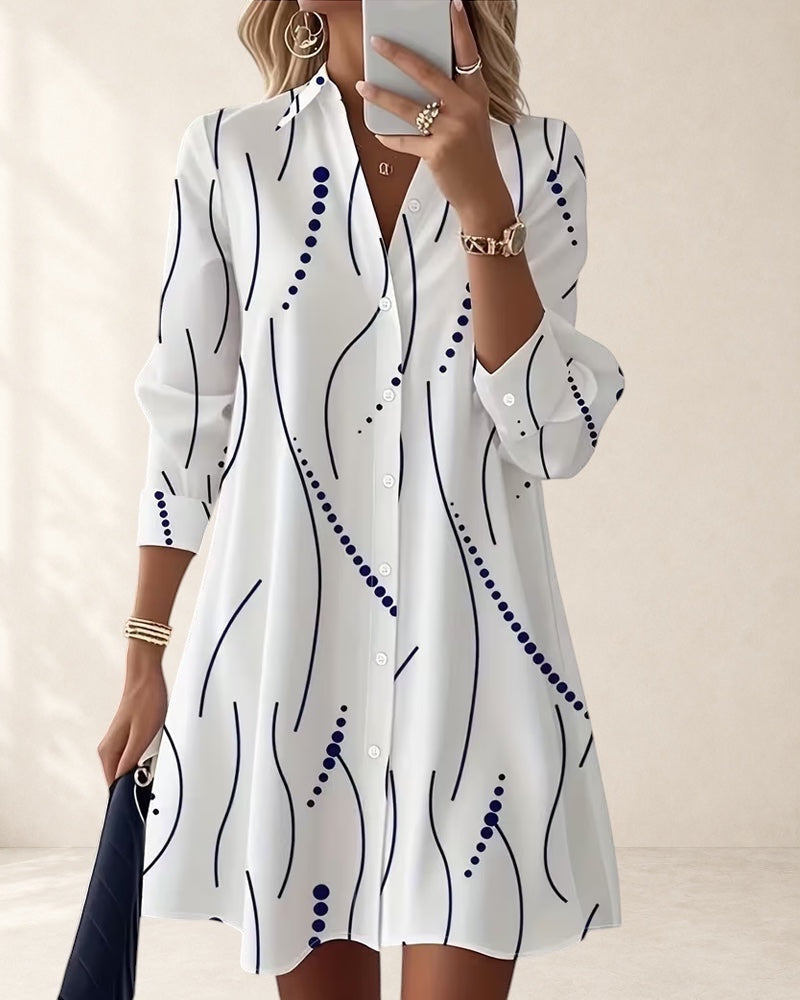 Vivian &amp; Cole white A-line dress with wavy blue stripe pattern, lapel collar, and button front. Above knee length.