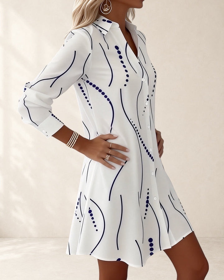 Vivian &amp; Cole white A-line dress with wavy blue stripes and dots pattern, lapel collar, long sleeves, above knee length.