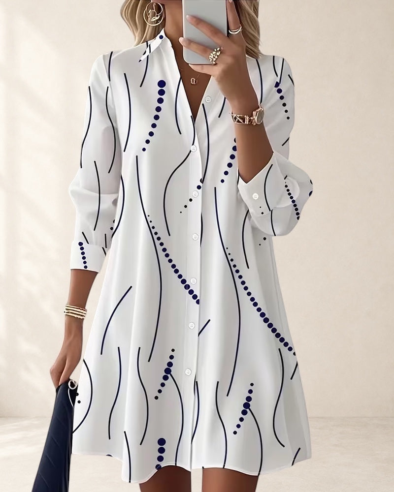 Vivian & Cole white A-line dress with wavy blue stripe pattern, lapel collar, and button front. Above knee length.
