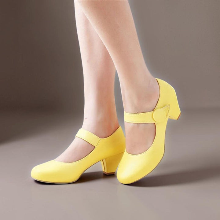 Vivian &amp; Cole Clementine yellow block heel Mary Jane shoes with an adjustable instep strap and rounded toe.