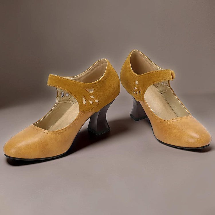Vivian &amp; Cole Guinevere yellow Victorian button strap heels with a stable flared heel and decorative cutouts.