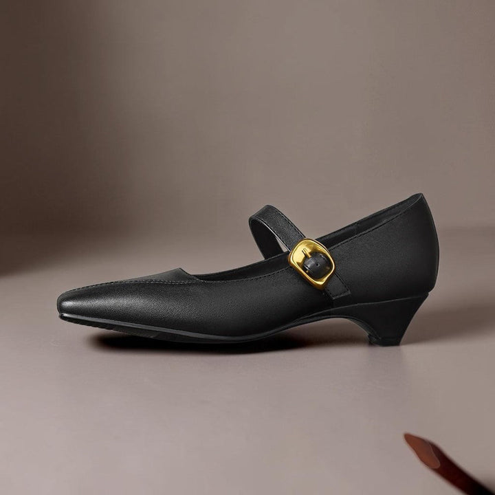 Vivian &amp; Cole Zorae black leather paneled Mary Jane heel with a statement gold-tone buckle and low block heel